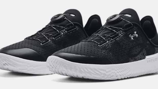 View of black and white Under Armour shoes.